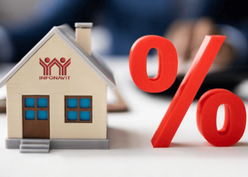 Small house model with Infonavit logo beside a large red percent symbol, suggesting home loan rates or financing.